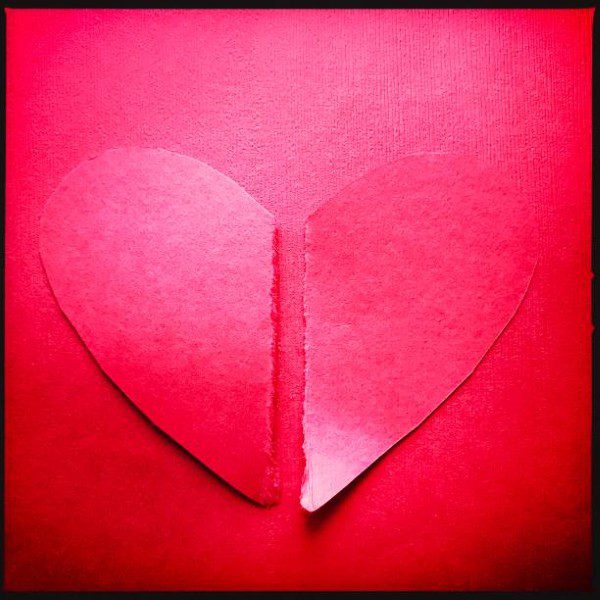 Paper red heart torn in two pieces. iPhone